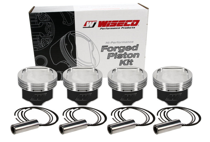 Wiseco Subaru WRX EJ20 stroker piston kit with four forged pistons and accessories in packaging.