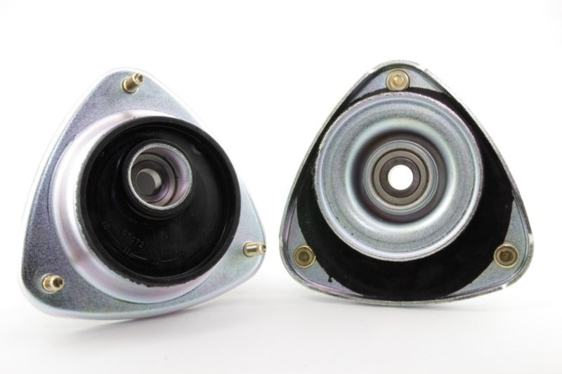 Subaru WRX strut mounts showing offset assembly design for caster or camber adjustments.